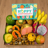 Thumbnail for Tropical Fruit Box gift set featuring pink pineapple, dragon fruit, mangoes, and manzano bananas with anniversary card
