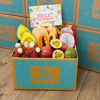 Thumbnail for Tropical Fruit Box filled with fresh passion fruit, pink pineapple, papaya, dragon fruit, avocado, and rambutan.