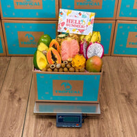 Thumbnail for Tropical Fruit Box assortment featuring pink pineapple, dragon fruit, mango, papaya, and avocado in a branded box.