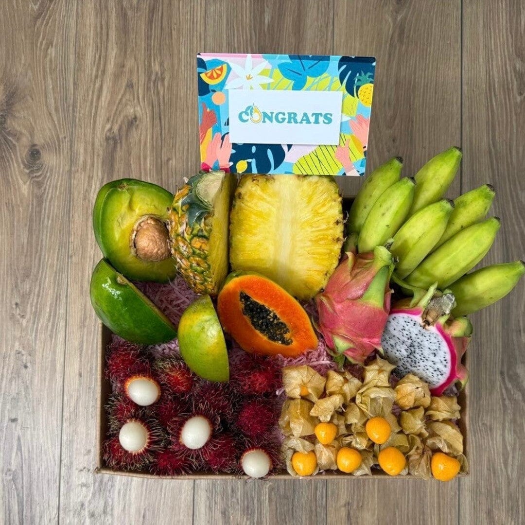 Tropical Fruit Box assortment featuring mango, pineapple, avocado, dragon fruit, bananas, and longans with a gift card