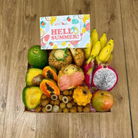 Thumbnail for Tropical Fruit Box assortment featuring pink pineapple, dragon fruit, mangoes, and avocados in a gift box.