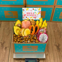 Thumbnail for Tropical Fruit Box Taste the Tropics fruit assortment featuring pink pineapple, dragon fruit, mango, and Manzano bananas.