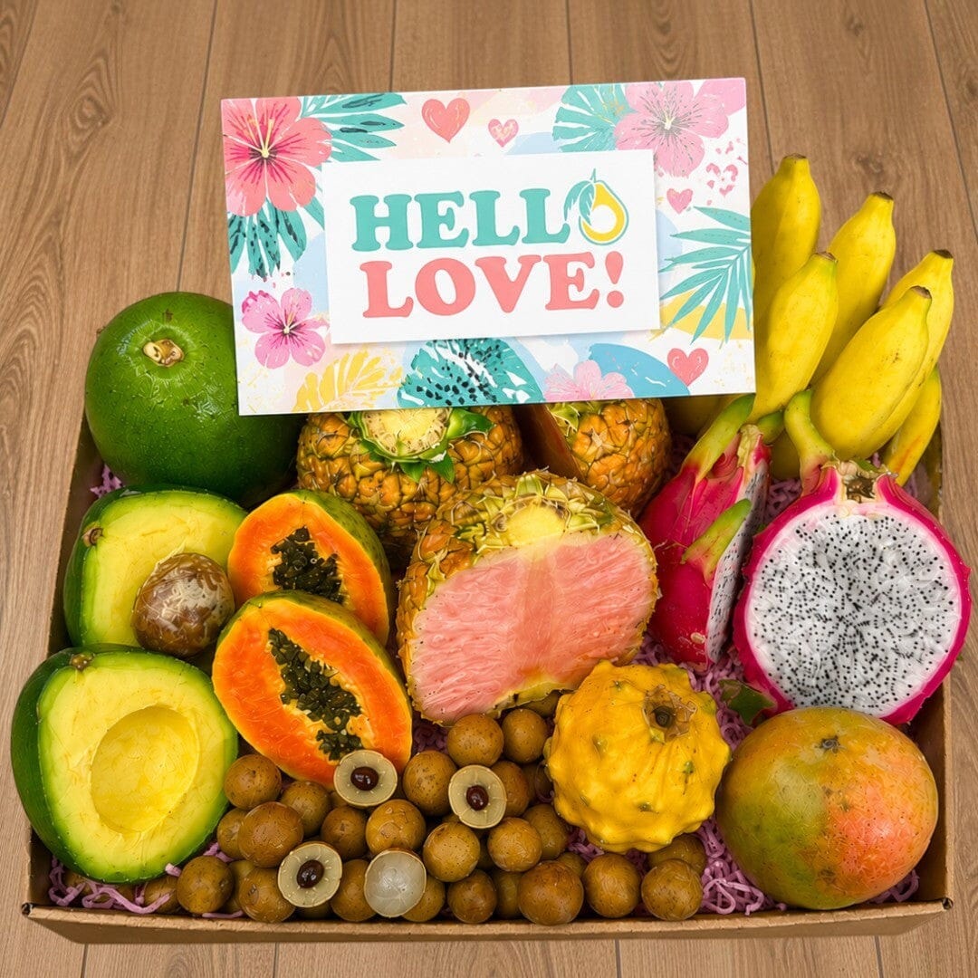 Tropical Fruit Box assortment featuring pink pineapple, dragon fruit, mangoes, avocado, and lychee with a gift card.