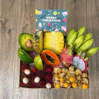 Thumbnail for Tropical Fruit Box gift set featuring mango, pineapple, avocado, dragon fruit, bananas, and rambutan with a card.