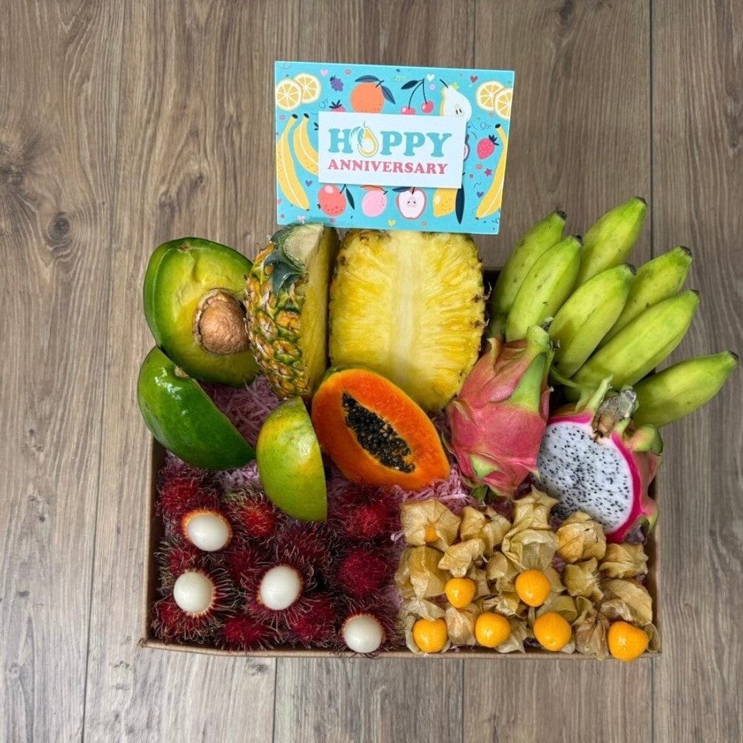 Tropical Fruit Box gift set featuring fresh mango, pineapple, dragon fruit, bananas, avocado, and exotic berries.