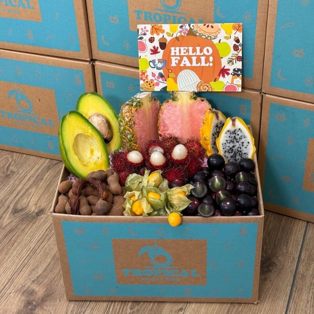 Tropical Fruit Box Tropical Fall Fruit Feast Box featuring pink pineapple, avocado, dragon fruit, and golden berries.