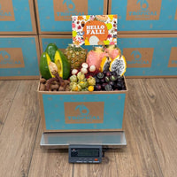 Thumbnail for Tropical Fruit Box Fall Feast gift box filled with assorted exotic fruits including pink pineapple, avocado, and dragon fruit.