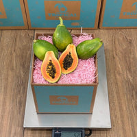 Thumbnail for Tropical Fruit Box Golden Papaya, 3 lbs box with 4 whole papayas and 1 cut in half showing golden flesh and black seeds.