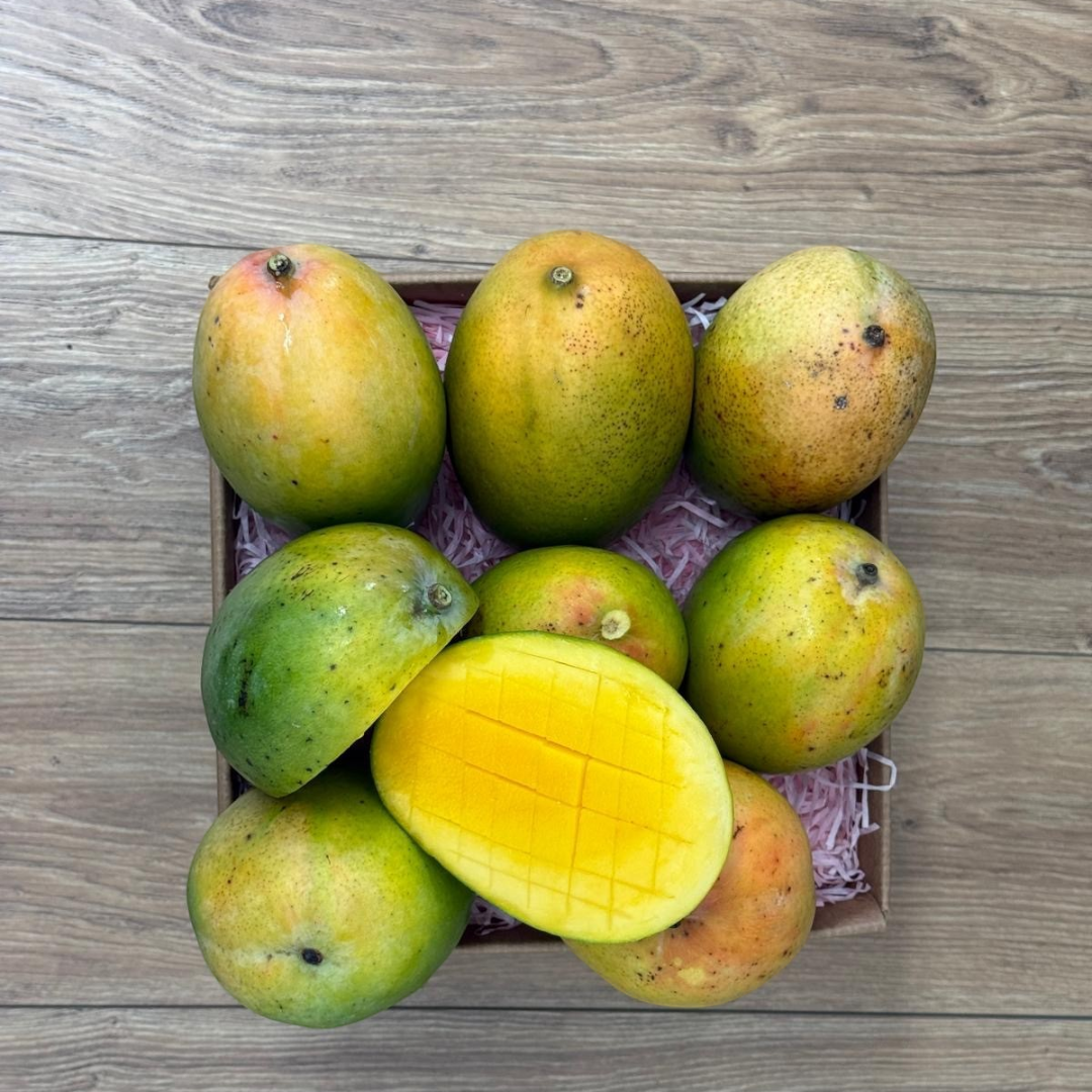 Tropical Fruit Box Florida-grown Kent mangoes with smooth green and yellow skin and juicy orange scored flesh