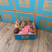 Thumbnail for Tropical Fruit Box purple guava fruit, some sliced showing pink flesh, in a blue branded box.
