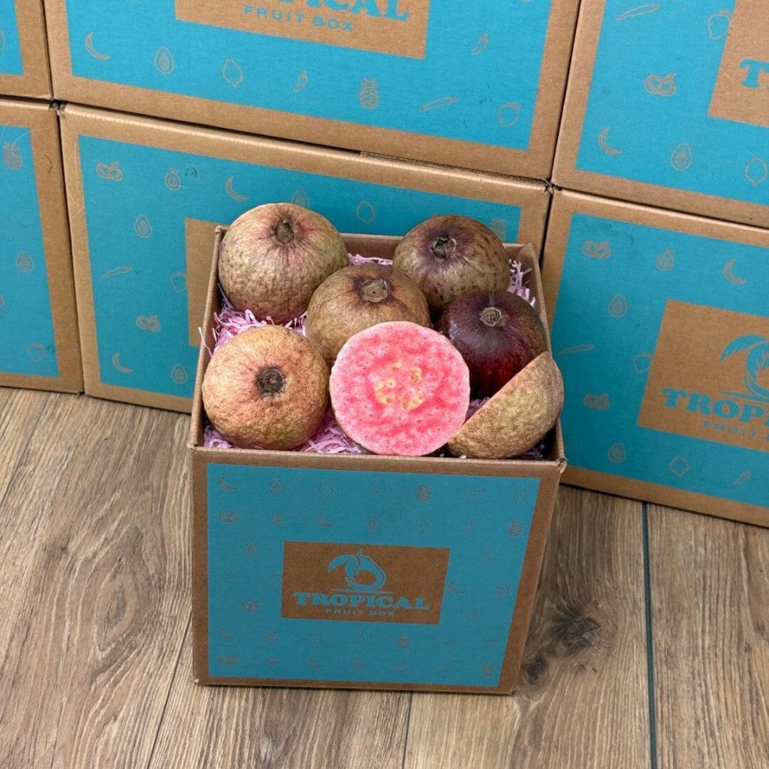 Tropical Fruit Box purple guava fruit with pink flesh, whole and sliced, in a branded box.