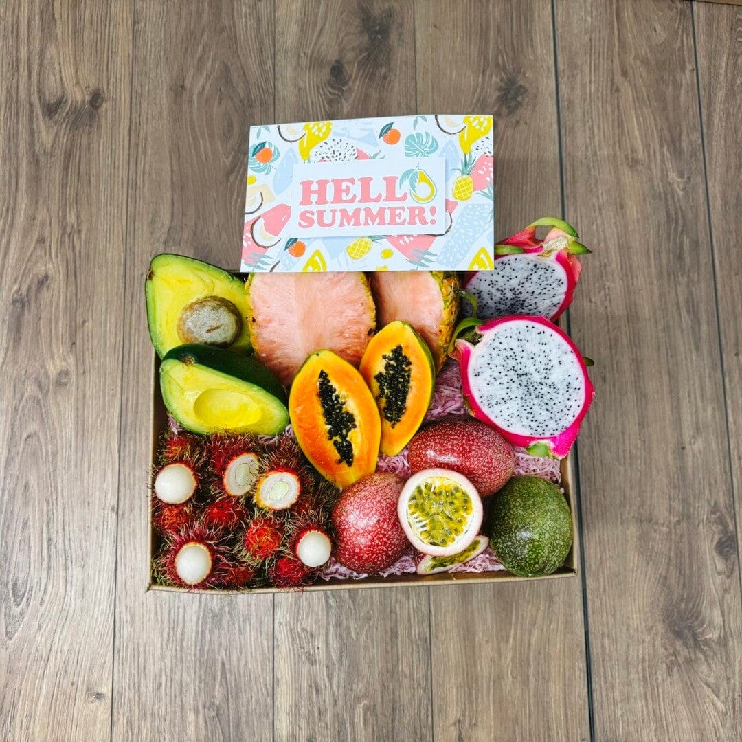 Tropical Fruit Box TropiSummer gift box featuring pink pineapple, dragon fruit, papaya, avocado, passion fruit, and lychee.